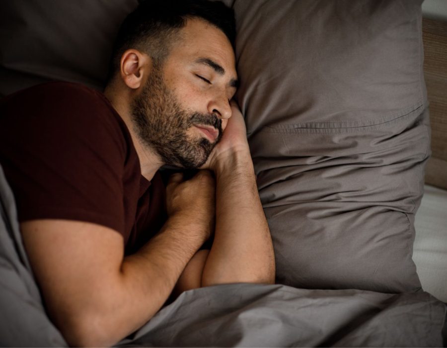 calm-young-man-with-beard-sleeps-bed-soft-pillow-blanket-bedroom-interior-3